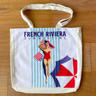 French Riviera Summertime cotton tote bag against a wood surface