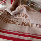 Tea towel with printed text and red stripes in a vintage-style