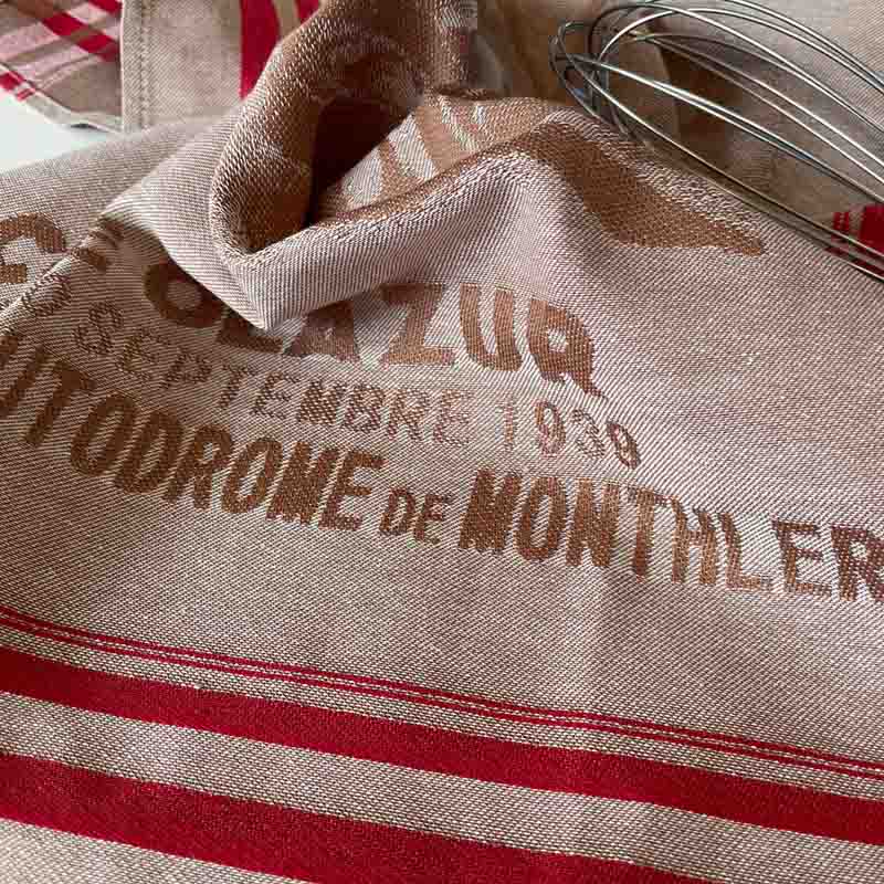 Tea towel with printed text and red stripes in a vintage-style