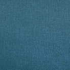 A close-up of a textured blue tablecloth fabric, showing a fine woven pattern.