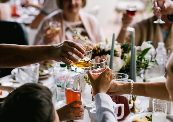 People toasting with glasses at a festive gathering