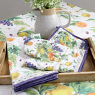 Set of table linens with fruit pattern on a wooden tray