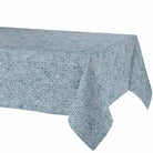 A rectangular tablecloth with a repeating blue and white floral or geometric medallion pattern, shown draped over a table against a plain white background.