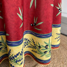 Colorful fabric with olive and lavender design on a red background
