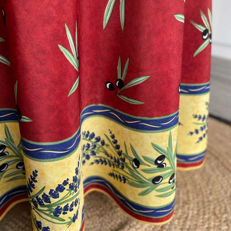 Colorful fabric with olive and lavender design on a red background