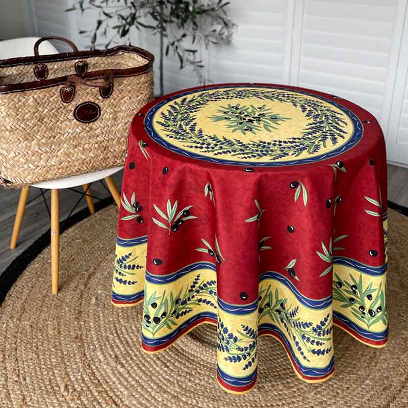 Decorative round table with a red and yellow pattern in a room setting.