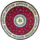 Decorative plate with red center and floral patterns on a white background