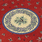 Decorative tablecloth centre with lavender and olive design on a red background