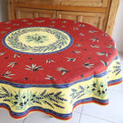 Round tablecloth with lavender and olive design on a wooden table.