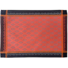Placemat with an orange and black pattern on a white background