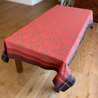 Orange and black jacquard tablecloth on a wooden table