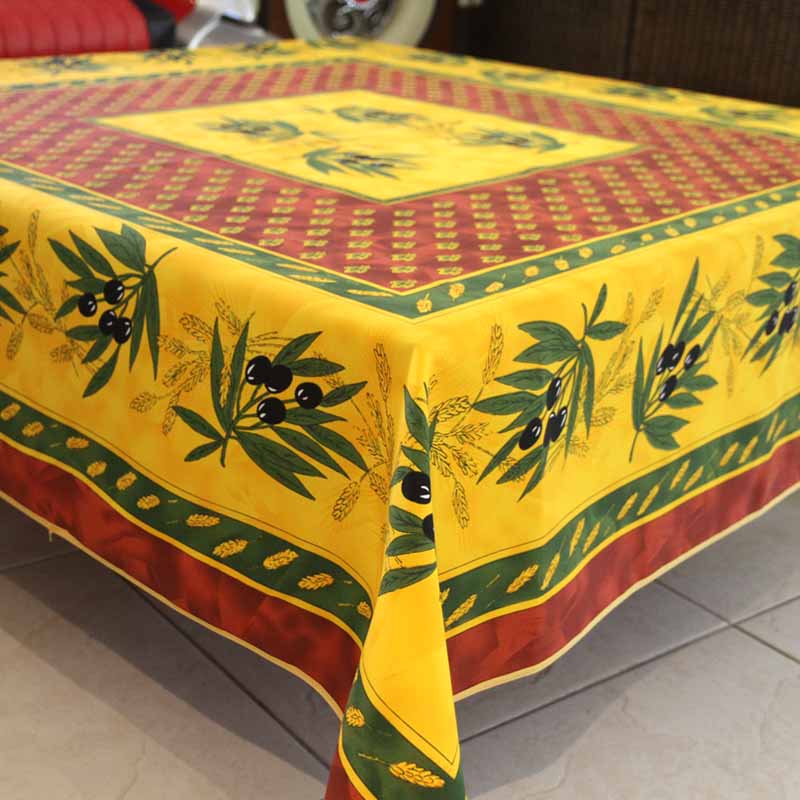 Yellow tablecloth with olive branch design and red highlights.