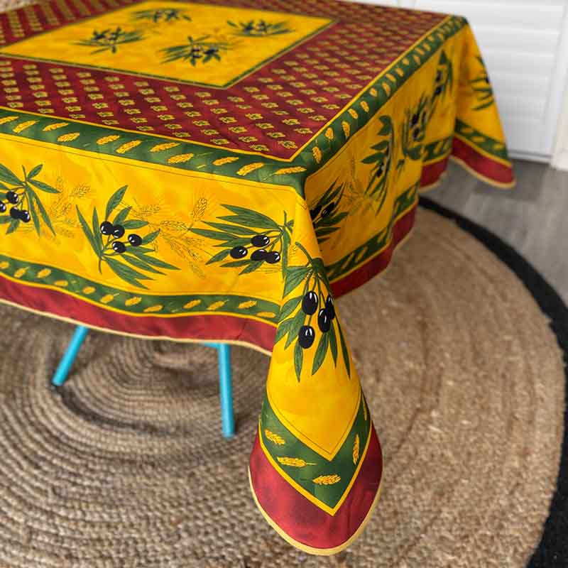 Border of a Provencale tablecloth with olive motif on a background of red, green and yellow.