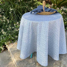 Round table with a blue patterned tablecloth outdoors