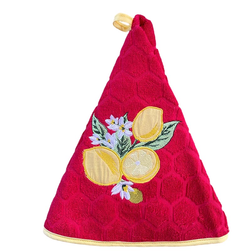 A round red hand towel with a honeycomb texture, featuring an embroidered lemon and flower motif on the front, finished with a yellow hanging loop at the tip.