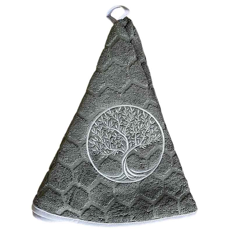 A dark gray textured kitchen towel with an embroidered tree of life design in the centre, hanging from a loop