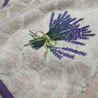 Embroidered lavender design on a textured fabric background