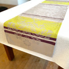 Table runner with yellow and purple design on a table