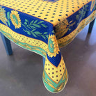 Decorative tablecloth with sunflower and blue pattern on a table.