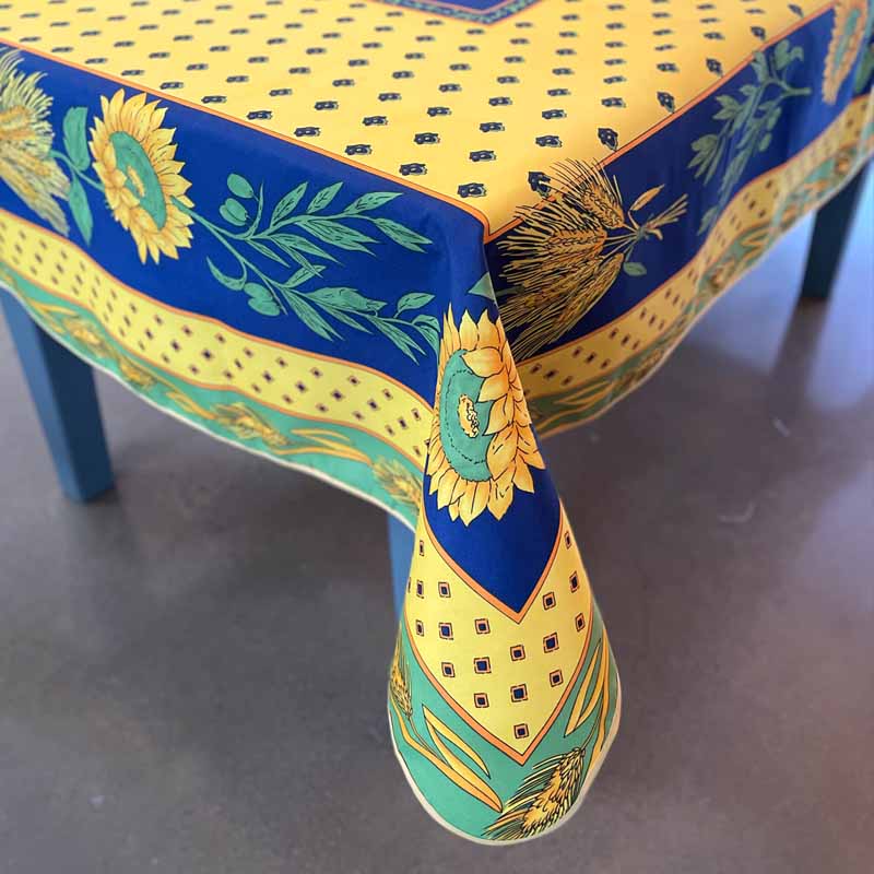 Decorative tablecloth with sunflower and blue pattern on a table.