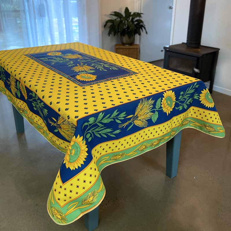 Tablecloth with sunflower design on a table in a room.