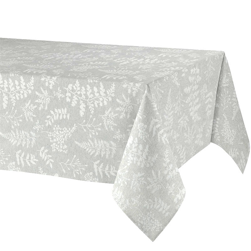 A light gray tablecloth with a subtle white botanical leaf pattern, draped over a table against a plain white background.