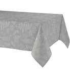A light gray tablecloth with a subtle white botanical leaf pattern, draped over a table against a plain white background.