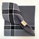 Gray napkin with black and white pattern on a textured surface