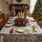 Laponia tablecloth on a Christmas dining table with red napkins and gold rimmed plates