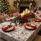 Angled view of the Laponia tablecloth with red napkins and a festive candle centrepiece