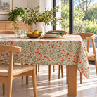 Wild Poppy floral tablecloth on a rectangular dining table with green napkins