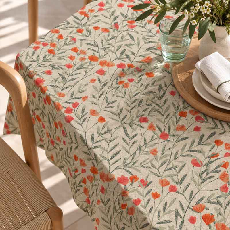 Closeup of Wild Poppy coral flowers and green foliage on a rectangular table