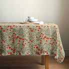 Wild Poppy floral tablecloth draped over a rectangular wooden table