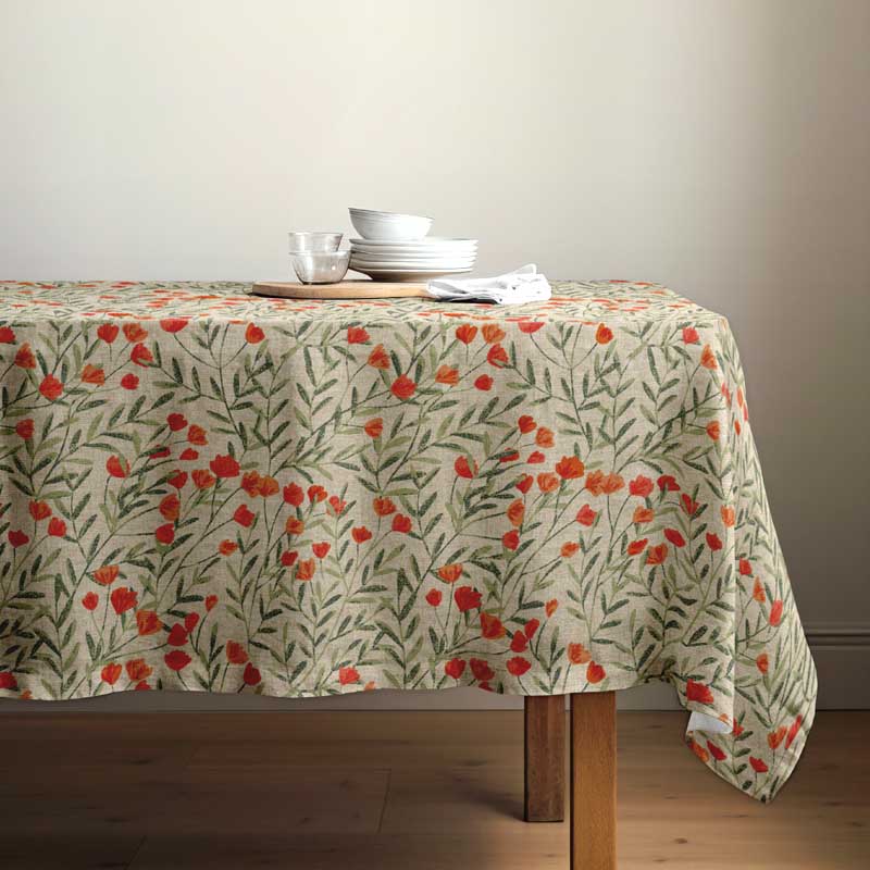 Wild Poppy floral tablecloth draped over a rectangular wooden table